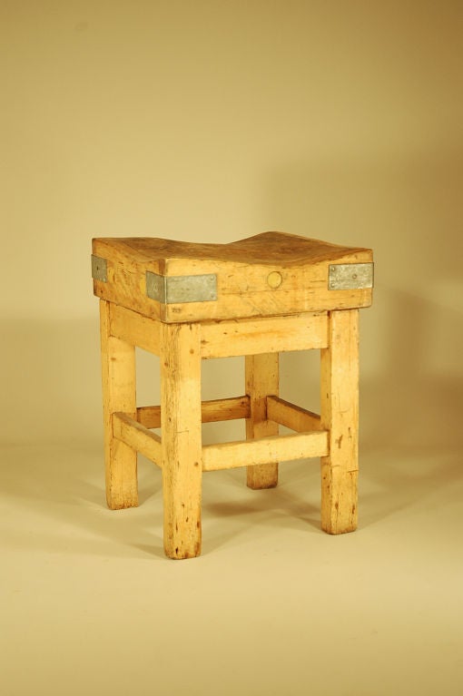 Beech butcher block top on pine table base. The top is made with wide thick planks containing the numerous end grain pieces that form the top. <br />
<br />
The outside corners have metal brackets. Bolts that hold the top together are capped with