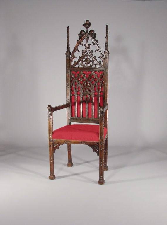 Stunning example of a Neo-Gothic arm chair with superb carving. Nice high pierced back with a removable panel. Upholstered seat and upholstered panel behind the back to highlight the tracery (fabric replaced). All in perfect condition. The patina is