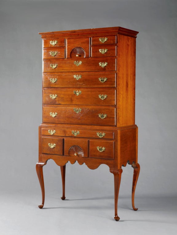 Weathersfield, Connecticut Queen Anne cherry highboy.<br />
<br />
The original cove molded rectangular cornice above the upper case with a fan-carved center drawer flanked by two short drawers over four long graduated thumbmolded drawers.<br