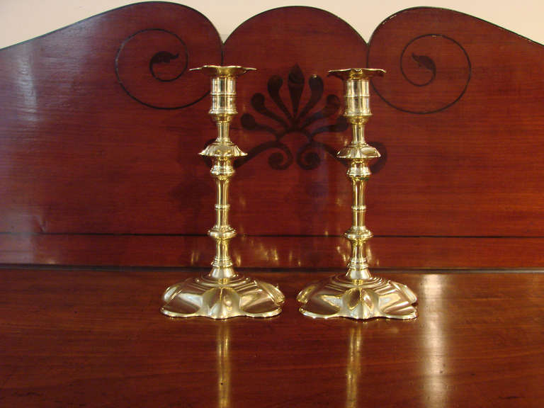 Excellent matched pair of English Queen Anne brass petal-base candlesticks.

Properly cast in halves.

Reference:  The Brass Book by Herbert Schiffer (page 199)