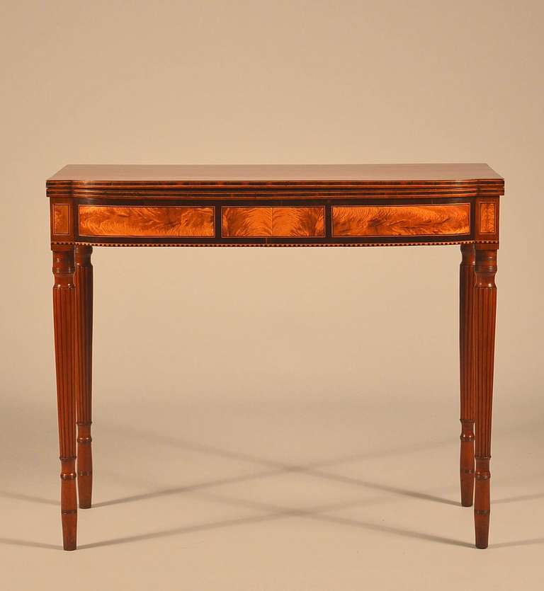 Excellent North Shore Massachusetts (probably Salem) mahogany card table with eleven panels of “Flame” birch.  
The sides of the front legs are usually covered by the side skirt so it's rare to have eleven panels.

The front skirt has three