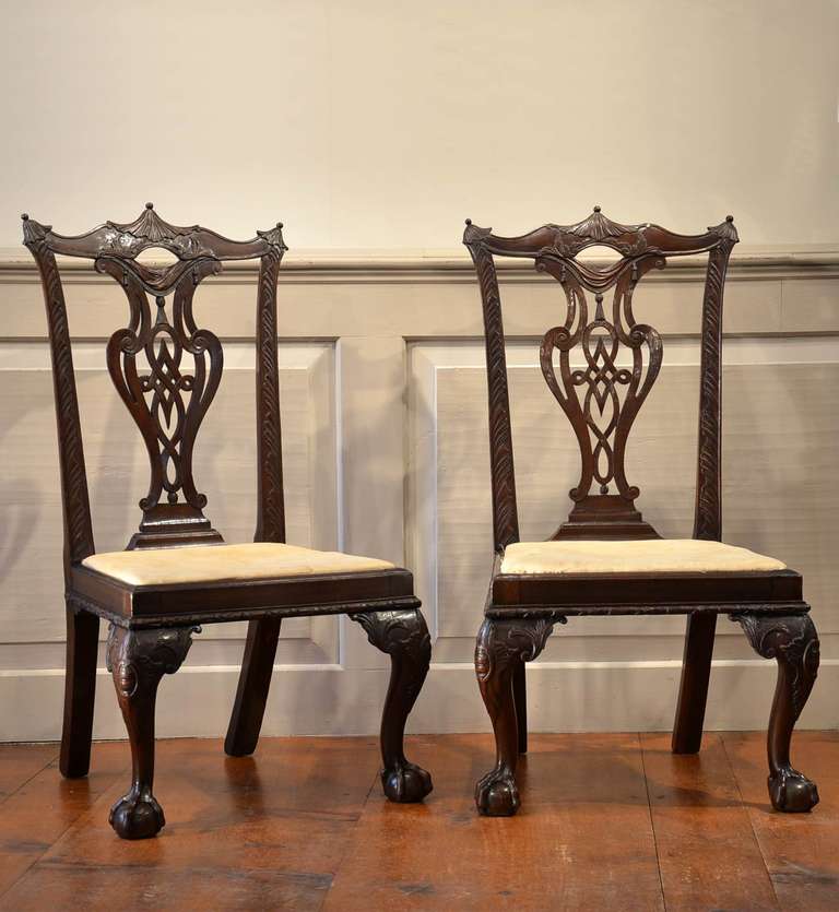 Pair of very rare mahogany Chippendale slipper chairs with elaborately carved backs with pagoda crest on very well carved ball & claw cabriole legs.

Slipper chairs are quite rare and to find a matched pair - even more so. 
Slipper chairs are