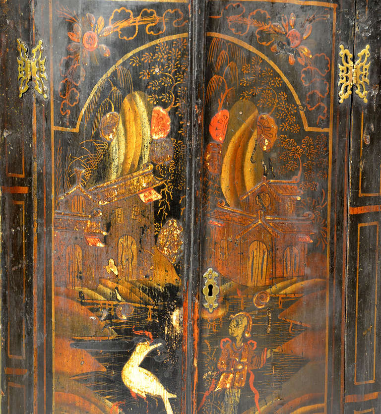 English George II Japanned bowfront hanging corner cupboard with the original pierced butterfly hinges, black ground with original polychrome decoration.