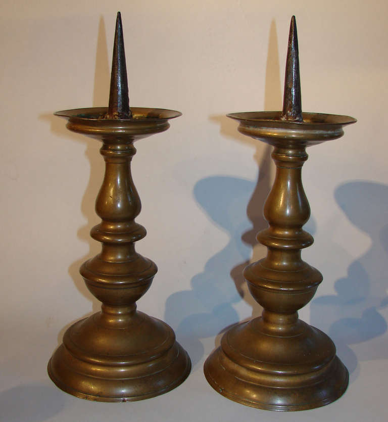 Pair of Dutch (Flemish) Baroque brass pricket sticks.
This type of candlestick solved the problem of casting a closed mold over 180º - by leaving both ends open (with the center sand cast held in place on a rod protruding out each end and secured