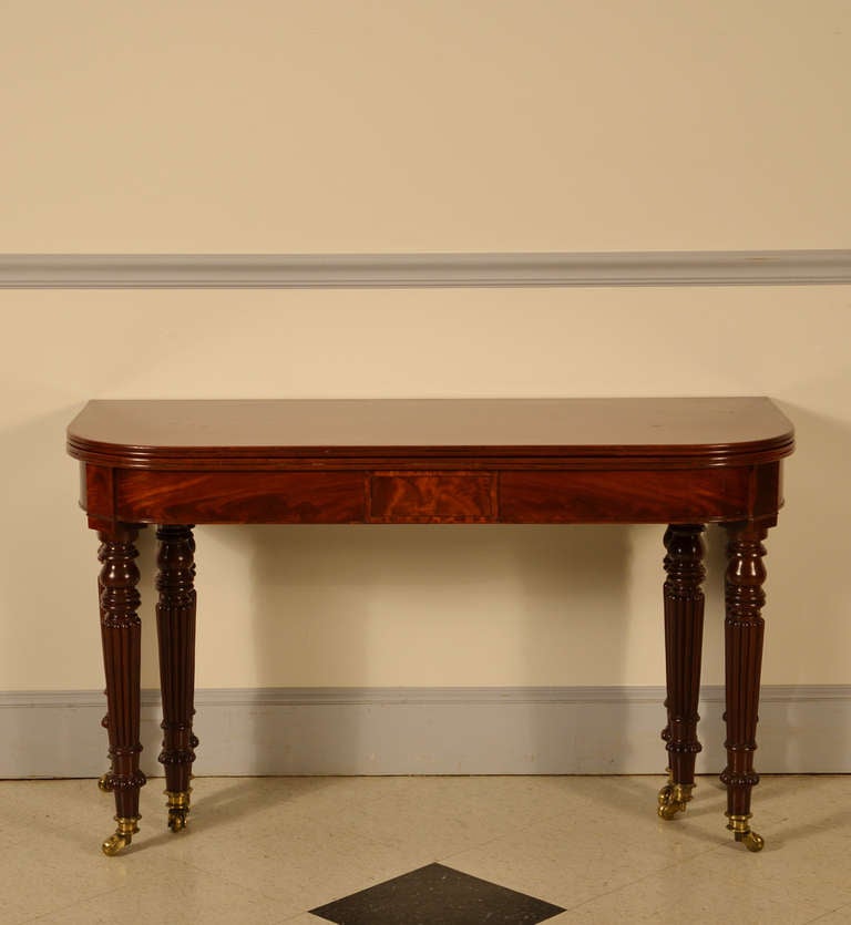 Fine and rare Regency fold-over banquet table, turned and reeded legs with original casters.     
Retains the four original leaves.

This table was made to be used in a Regency town house (long and narrow - like a Brownstone) so it can collapse