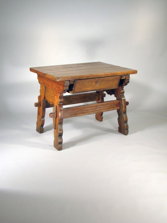 A Bakers Table with a lovely thick top, shaped base, and one drawer. The original pegging on the side and the 'S' joining of the top can be seen on the edge. The base is of the early wedge construction. Great patina on the top.