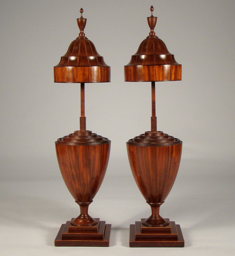 Wonderful pair of Regency mahogany knife urns that are unusually slender. 
They have truly great mahogany finials.
The interiors are all perfect.

They have great stance. 