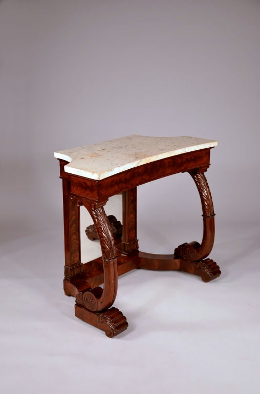 Superb Philadelphia Neoclassical mahogany pier table with very unusual concave front and half concave sides. Wonderful bold neoclassical carved elements.<br />
<br />
The shaped marble top is original and conforms to the concave front. The sides