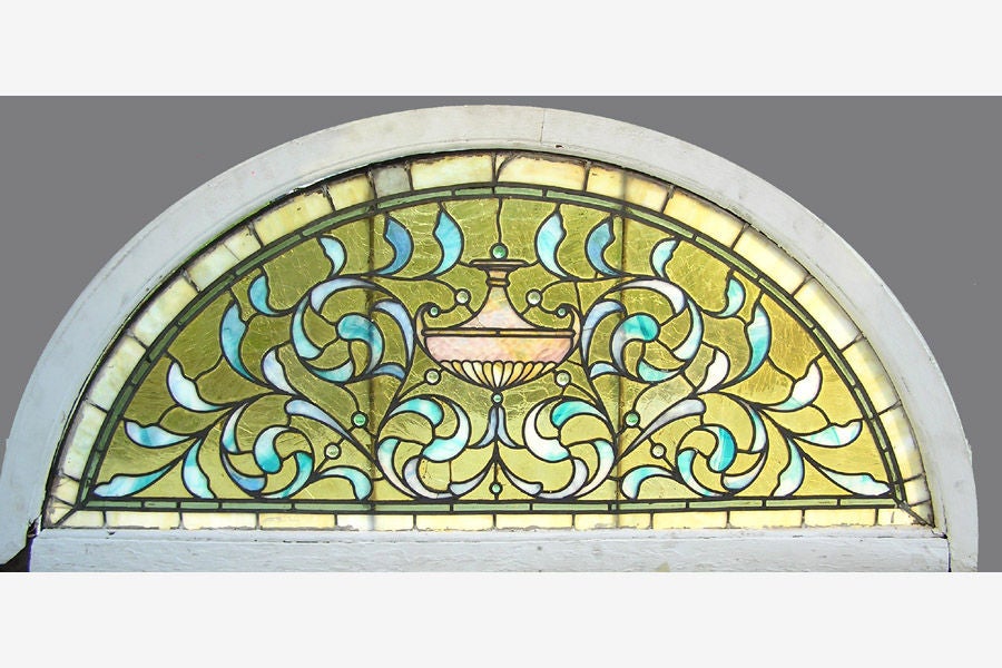 Stained glass window transom. The window has shades of turquoise and green glass, with center urn surrounded with 13 jewels. Removed from the Dernley mansion located on Flamingo st in Philadelphia