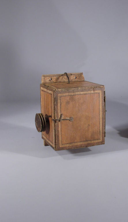 Early French spit engine in the original grain painted box. This is the type that the rope exits the top and uses pulleys to use an external weight for power. When the spit engine uses all of the rope it sounds a bell to alert the cook that the spit
