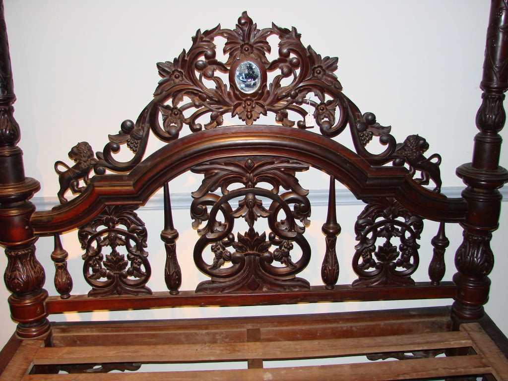 This bed is from the Governor House in Calcutta, India which was the seat of the English government of all of India in the 19th century.  This mahogany bed is a tour-de-force of Anglo/Indian furniture. The original cornice is carved with stylized