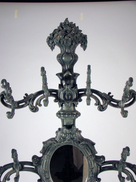 Rare cast iron Philadelphia hall tree with oval mirror and eight hooks.<br />
<br />
Signed by “Wood and Perot, Phila.”  <br />
From the estate of Cynthia Phipps.