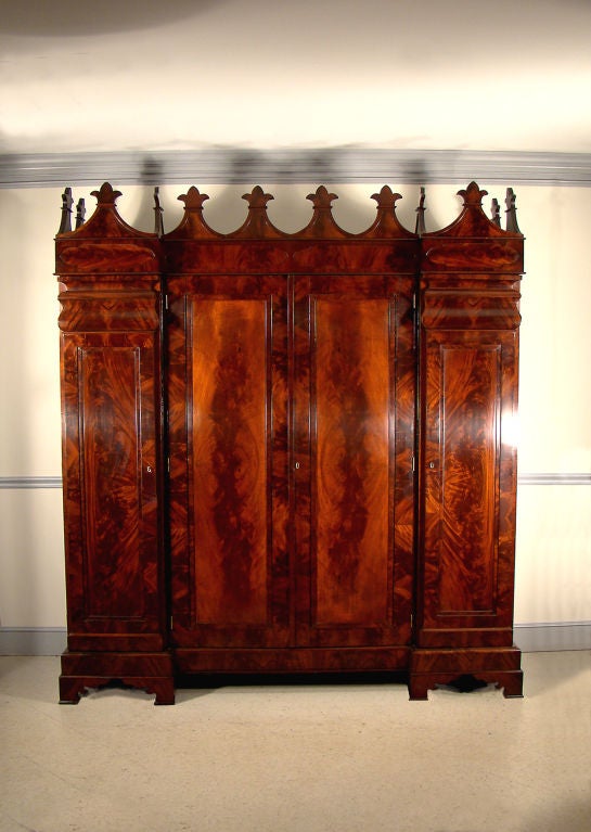 Rare American Gothic Revival carved mahogany three-part wardrobe from Baltimore, MD.<br />
<br />
This mahogany wardrobe has wonderful fully developed detail and superb 'flame' mahogany veneers.<br />
<br />
The mahogany wardrobe center interior