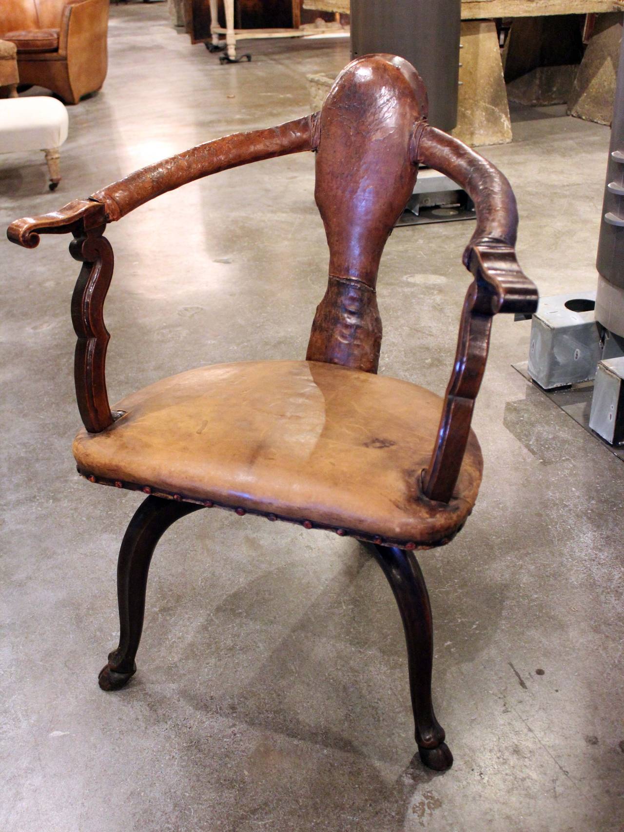 Incredible Italian walnut and leather swivel chair.