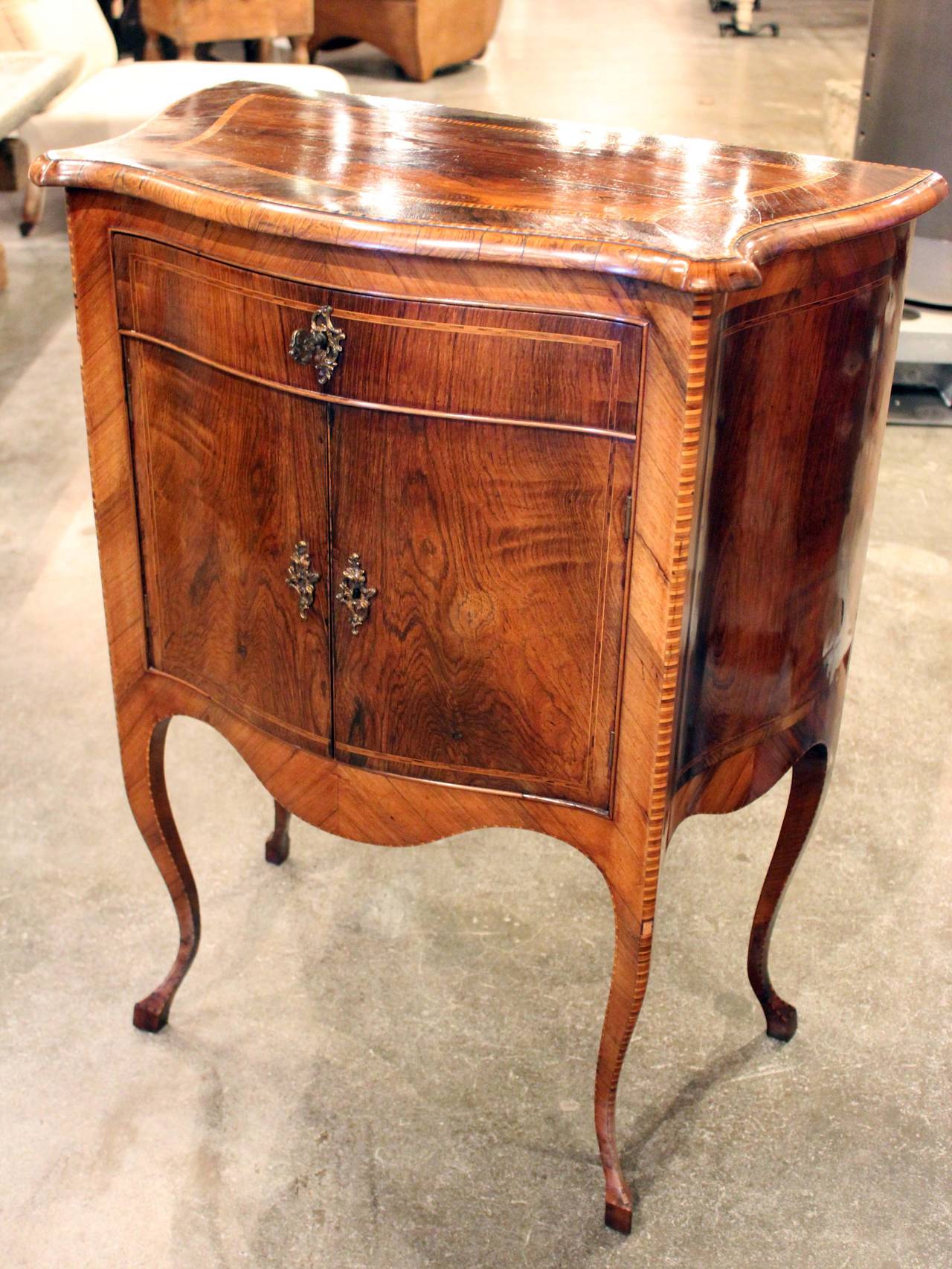 Italian walnut and satinwood side cabinet with elegant legs, single-drawer, two-door storage.