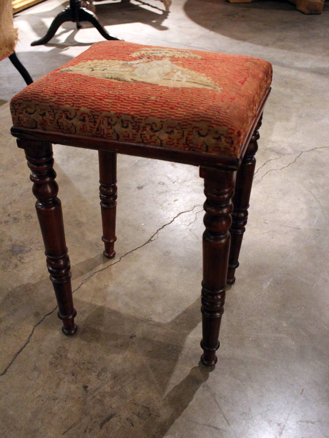 English tall stool with turned legs and needlepoint seat.