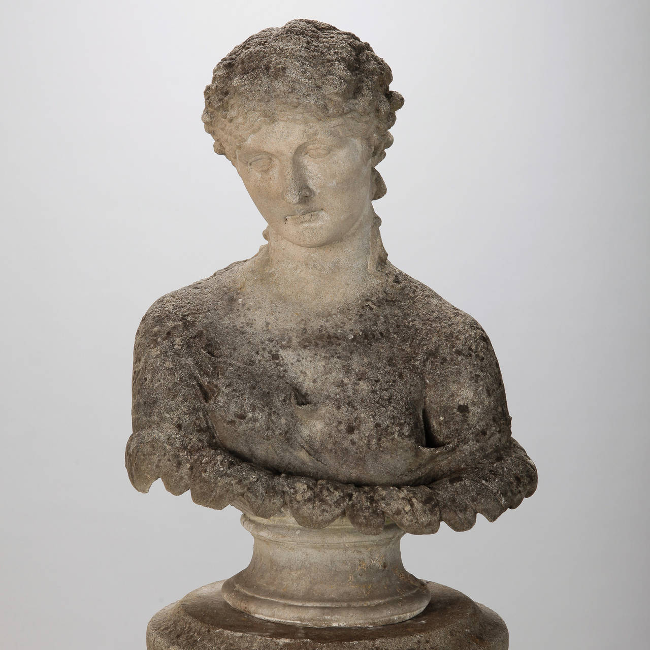 19th Century stone garden statue found in France is a beautifully detailed bust of a classic Greek goddess with coordinating reeded column display stand. Surface shows age and patina from outdoor elements.