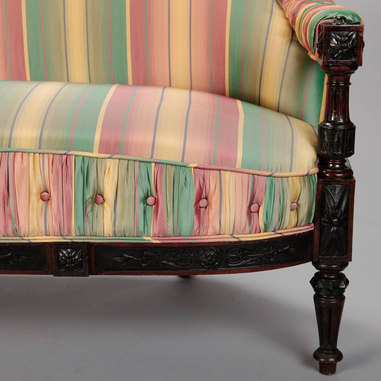 Circa 1860s small Spanish sofa or settee newly upholstered in striped silk taffeta. Top edge of back and arms and and front facing panel on bottom cushion are ruched and button tufted. Dark wood frame has turned legs and carved details. Seat is 16”