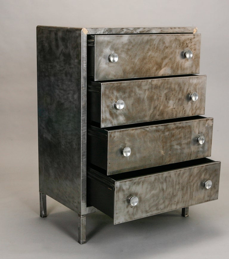 Circa 1945 chest of four drawers rendered in polished steel with round handles. Designed by renowned industrial designer Norman Bel Geddes. 