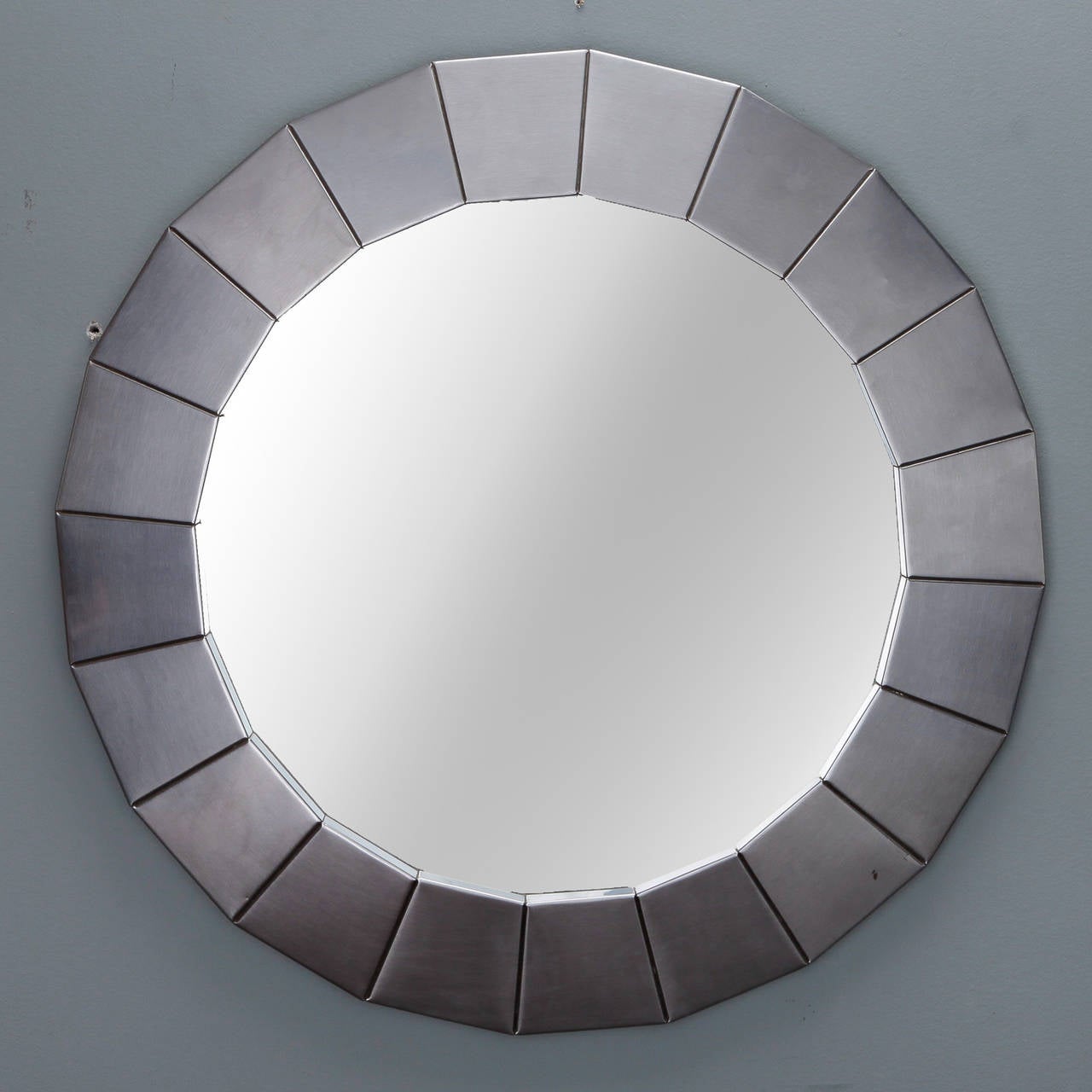 Circa 1960s round mirror with wide frame of silver tone brushed finish metal. 