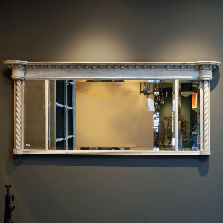 Turn of the century three section mantel mirror has a bleached oak frame with barley twist columns and a decorative pediment.