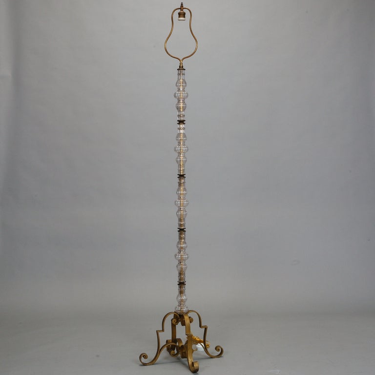 Circa 1930s floor lamp has a gilded metal frame with scrolled feet and ornamental glass pieces. New wiring for US electrical standards. Two available - not a pair but very similar. Found in France but not sure of origin.