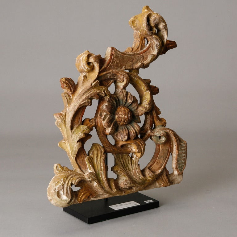 Carved wood architectural fragment with floral and foliate detail. Includes custom-made iron display stand. 