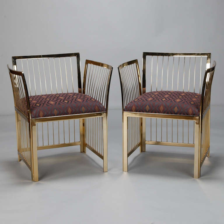 Pair of brass frame armchairs with upholstered seats and fine spindle details on the back and sides. Seats are 18.5” high and 19” deep. Arms are 26” high. Sold and priced as a pair.