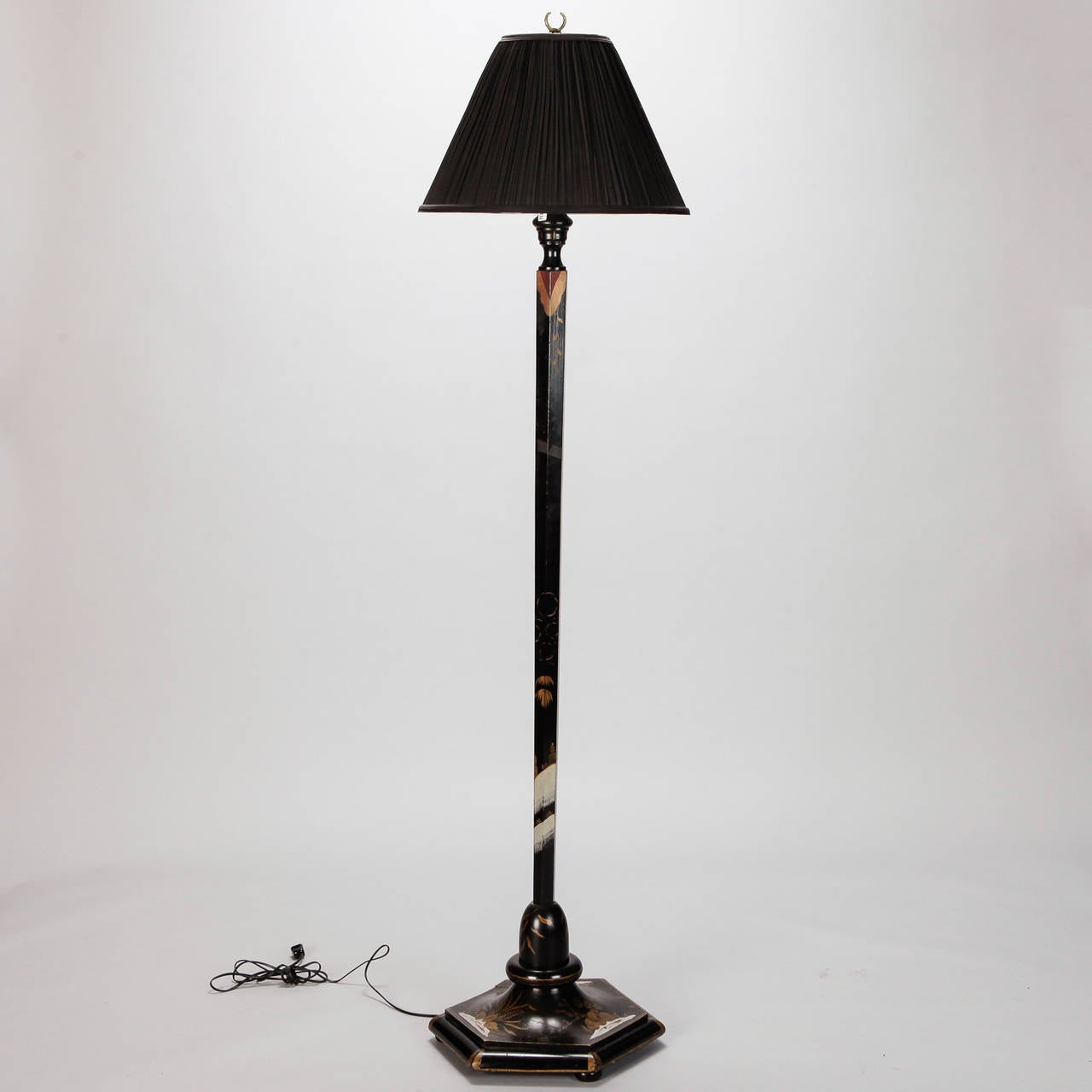 Circa 1920s English wood floor lamp with black painted and gilded finish in a Chinese motif. Octagonal base, black fabric shade and new wiring for US electrical standards.  

Shade:  18” w x 13” h x 18” d