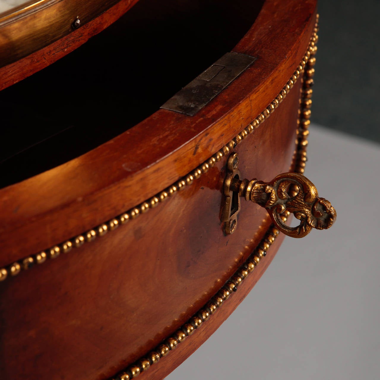 Circa 1900 French demi lune table has functional center drawer, brass mounts and galleries, white marble table tops and reeded legs.