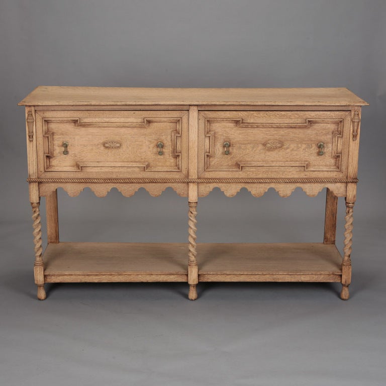 Circa 1920 bleached oak William and Mary style sideboard with barley twist legs, a scalloped apron and two large functional drawers.