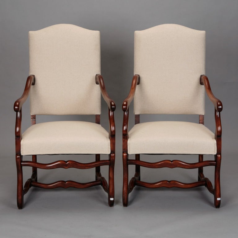 Handsome and generously sized pair of Os de Mouton style armchairs have been reupholstered in a neutral natural colored linen. Sold and priced as a pair.
