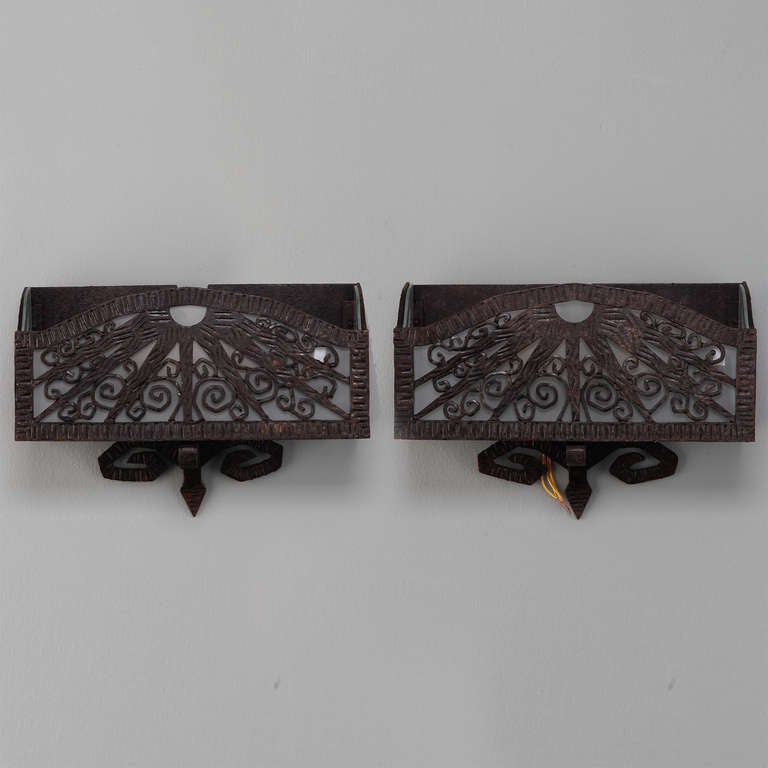 Pair of forge wall pocket sconces with glass inserts in the manner of Edgar Brandt, circa 1930s.