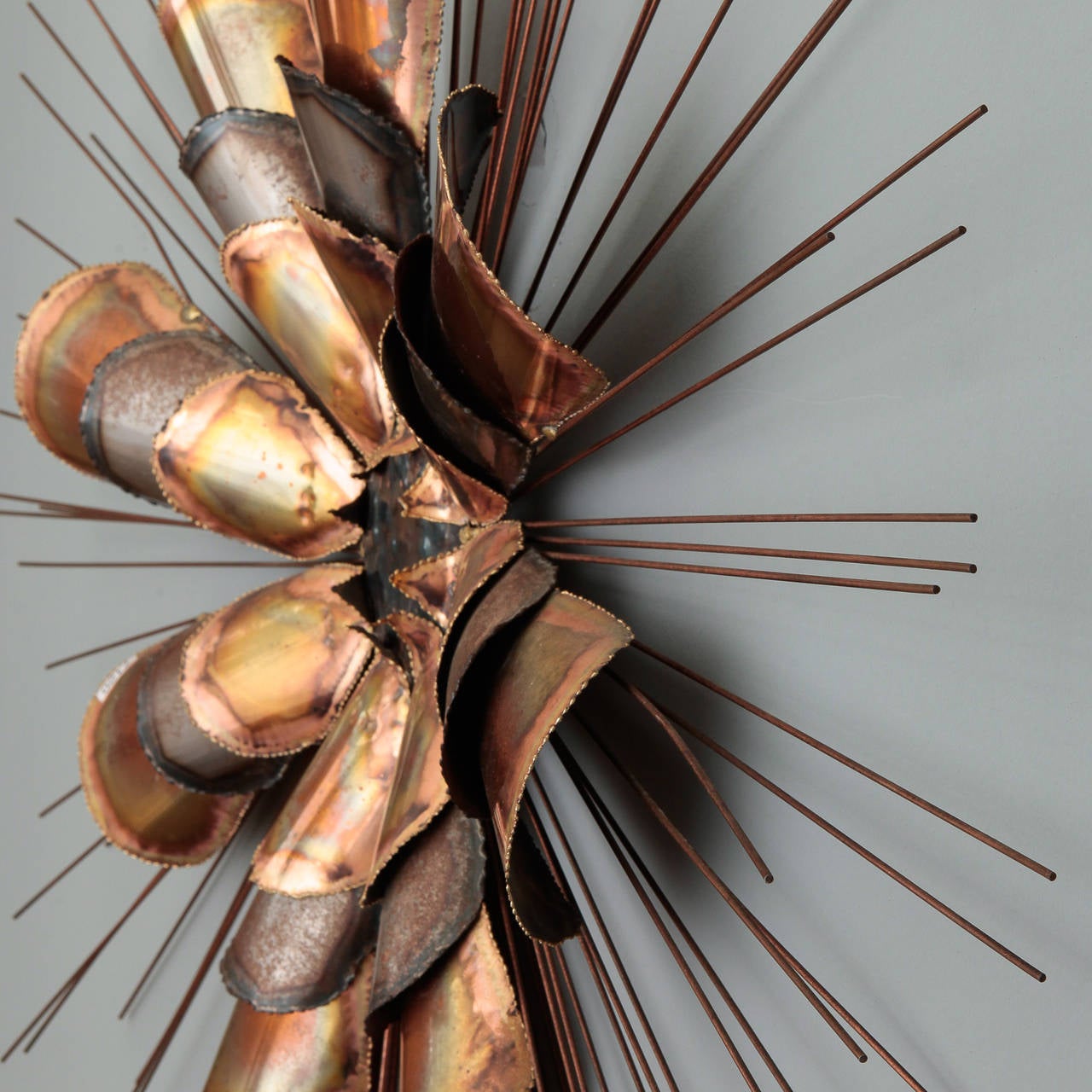 Circa 1970s large, brutalist style sunburst wall sculpture in copper and metal designed by artists Curtis Freiler and Jerry Felsby whose work is signed C. Jere or Curtis Jere and manufactured by Artisan House.
