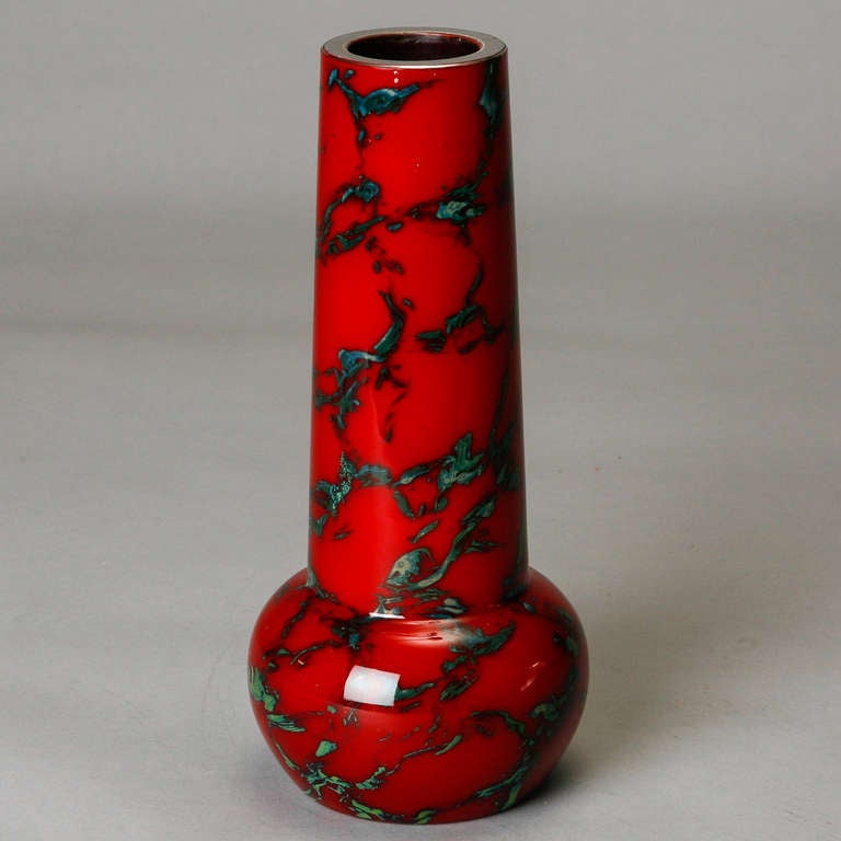 
Circa 1930s French Art Deco era vase in marbelized red and green opaque glass with tall cylindrical neck and round base. 