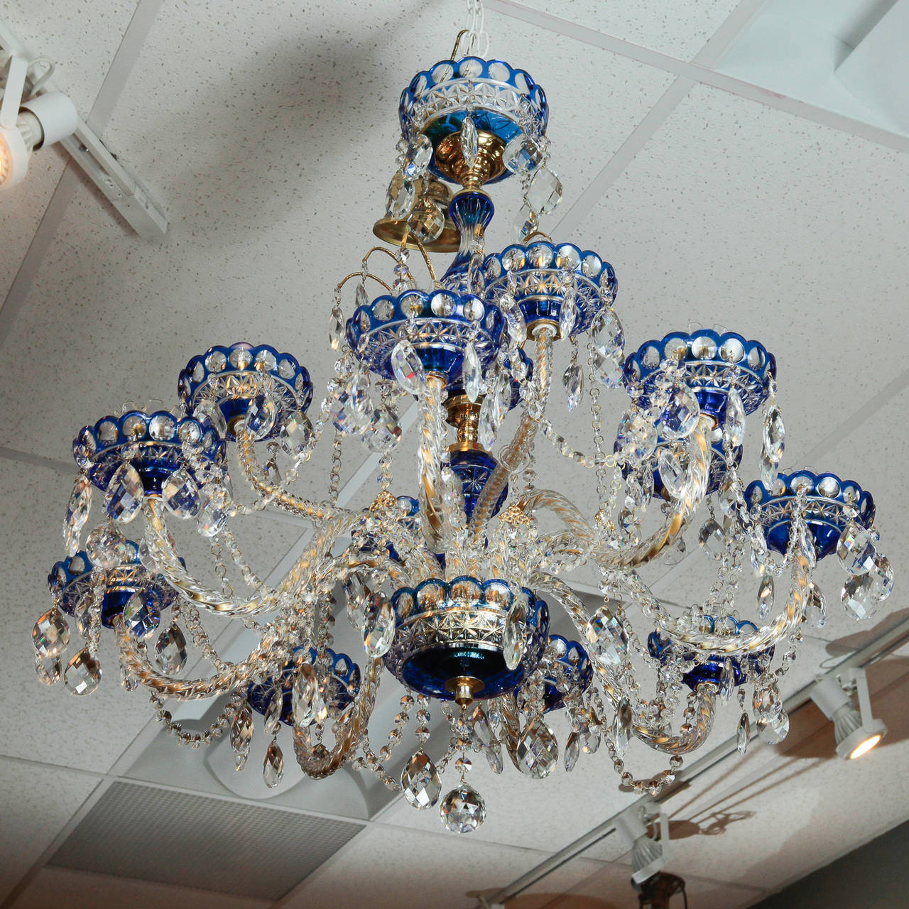 Stunning circa 1900 large Dutch twelve-light chandelier in cobalt blue cut to clear crystal. Cobalt blue crystal cut to clear center shaft, ceiling canopy, bobeches and bottom bowl. 12 clear twisted crystal candle arms, clear faceted tear drop