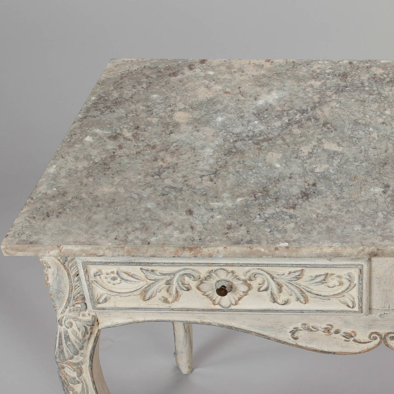 Circa 1900 French painted table with two narrow drawers, curved apron, cabriole legs and decorative details of carved flowers and leaves. Versatile size - use it as a console, ladies writing desk or side table.