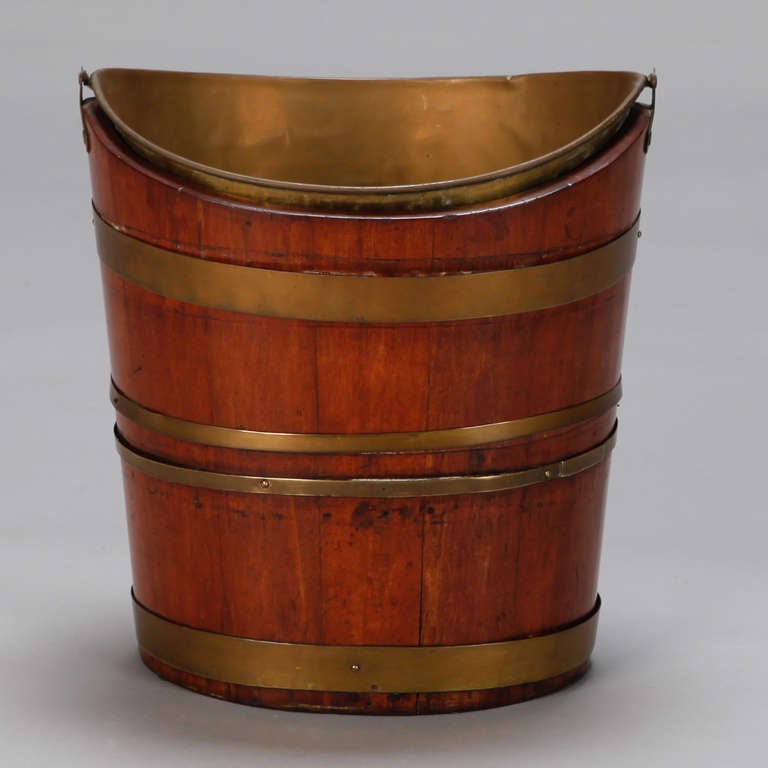 Circa 1880s Dutch ash bucket made of mahogany with copper bands and a copper liner/insert and handle.