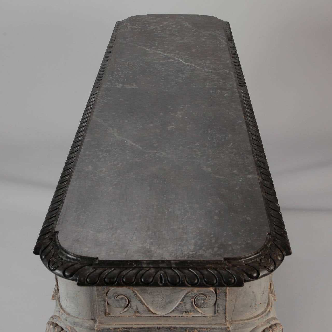 Circa 1900 French console with gray painted finish. Claw and ball feet, cabriole legs with shell form design at knees, carved stylized crested wave border on apron and charcoal faux painted marble finish top with decorative carved border.