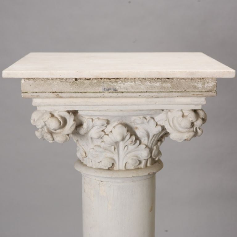 This plaster column table has a stepped base, the supports have elaborately sculpted fronds and the piece is finished with a removable white marble top.