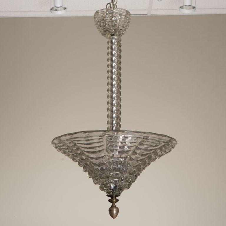 This Italian Art Deco era all glass Murano fixture has a clear glass ridged shade with twisted shaft, and bronze center piece.