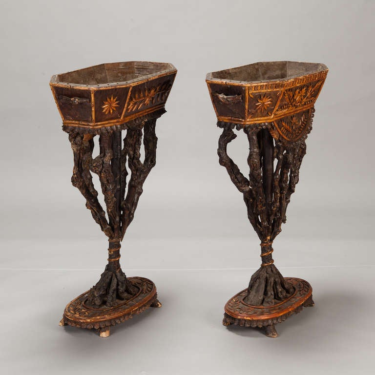 Circa 1840s pair of standing French jardinieres have hand carved and decorated planters with twig supports and carved pedestal bases. From the Ardeches Mountains. Sold and priced as a pair. 