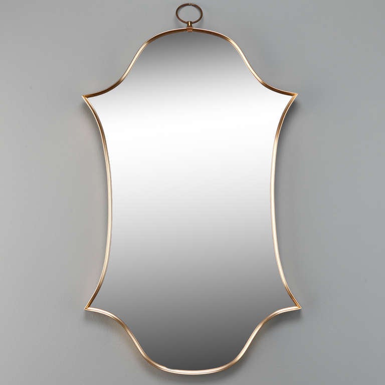 Pair Mid century Italian circa 1970s brass framed mirrors have an elongated double shield form shape with a brass hanging loop at the top.