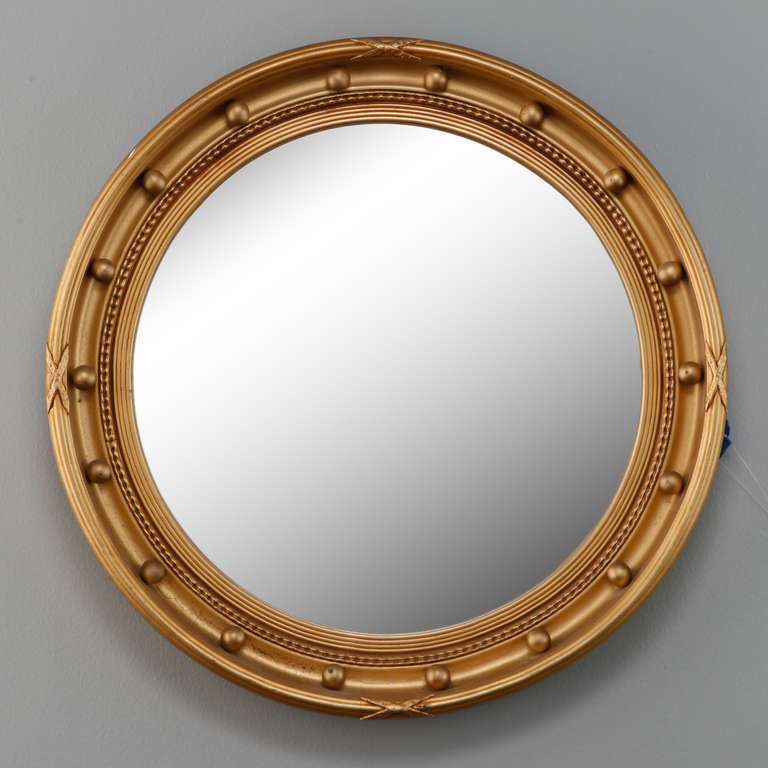 Circa 1920s round mirror in a gilded wood frame inset with large round wood beads.