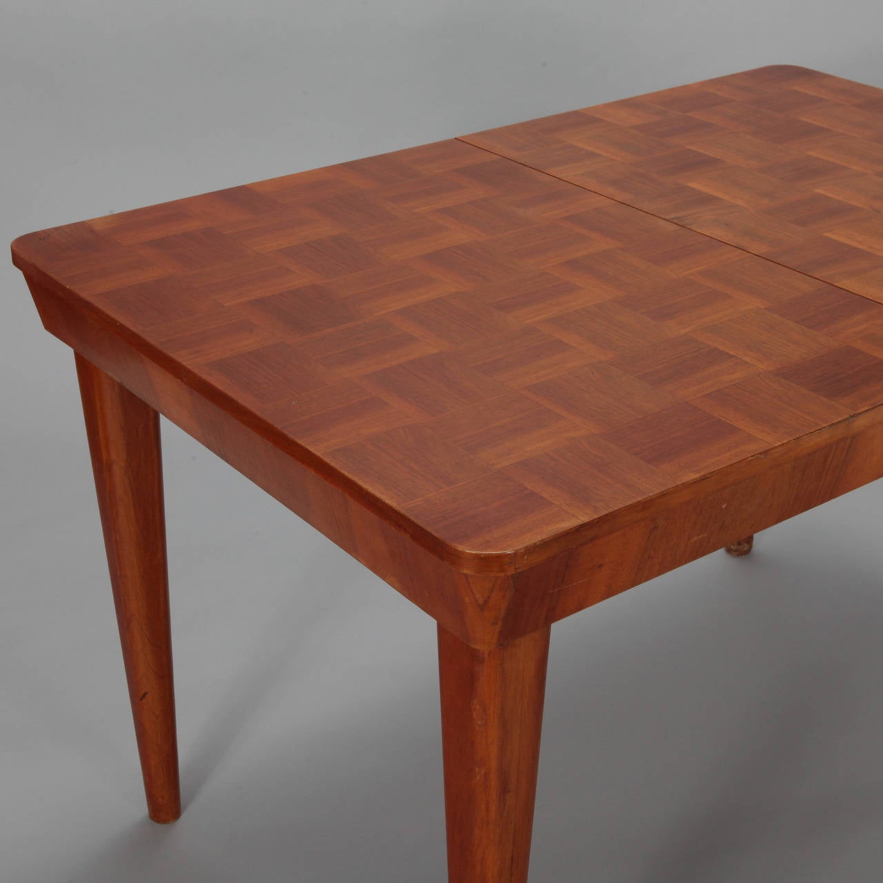 Jindrich Halabala for UP Zavody dining table with checkerboard style veneer surface with self storing leaf.