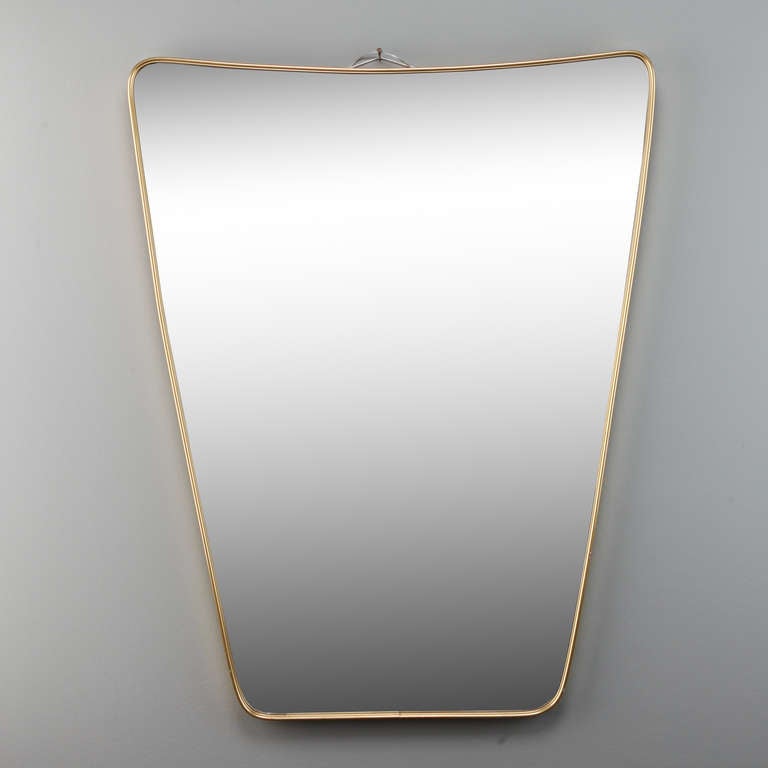 Circa 1960s Italian trapezoidal form mirror with minimalist brass frame in the manner of Gio Ponti.