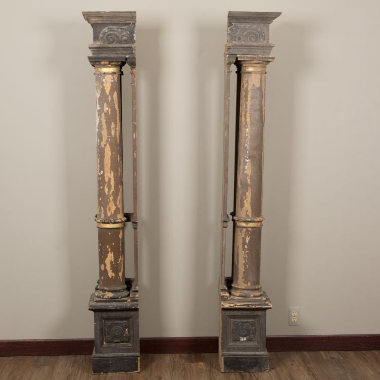 Pair of carved wood columns with original charcoal gray painted finish, carved medallions on base and corner pieces. Sold and priced as a pair. We have other columns in other sizes and finishes as well, please inquire if interested.