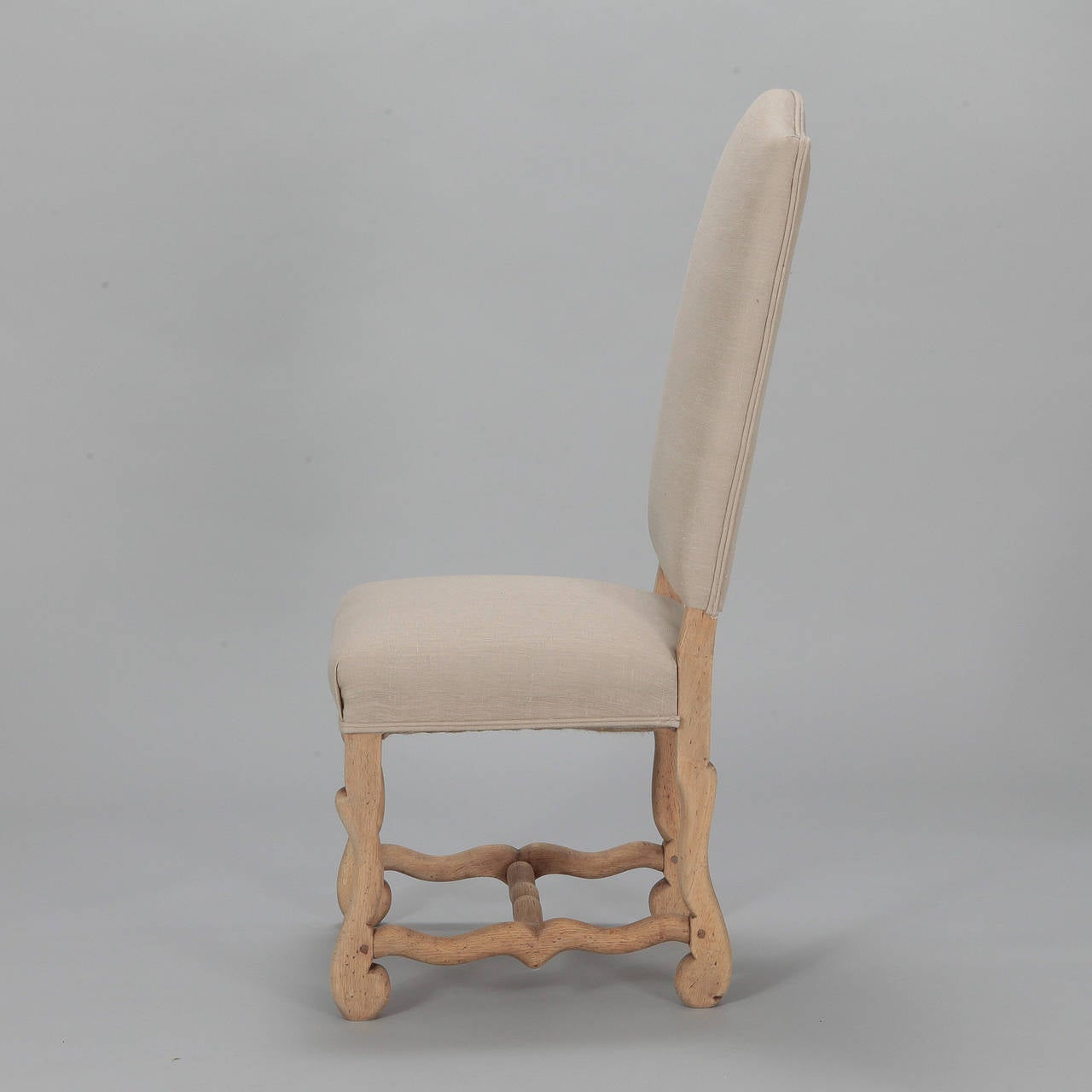 Circa 1920s set of eight Os De Mouton side chairs with bleached oak frames and new, natural color linen upholstery. Seats are 19” high and 16.5” deep. Sold and priced as a set.