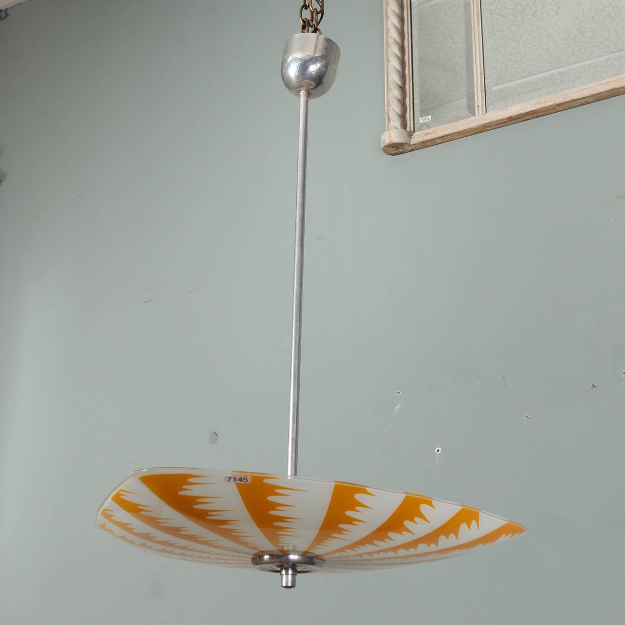 Circa late 1970s / early 1980s European Op Art ceiling fixture (we believe this is German) with bold, graphic pattern in opaque white and sunflower yellow / orange glass with metal hardware. New wiring for US electrical standards.