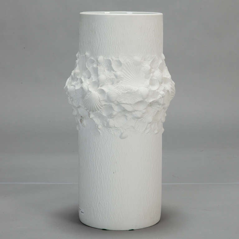 Mid century Bavarian vase of matte / bisque finish porcelain has a cylinder shape with large, sculpted band of shells. 